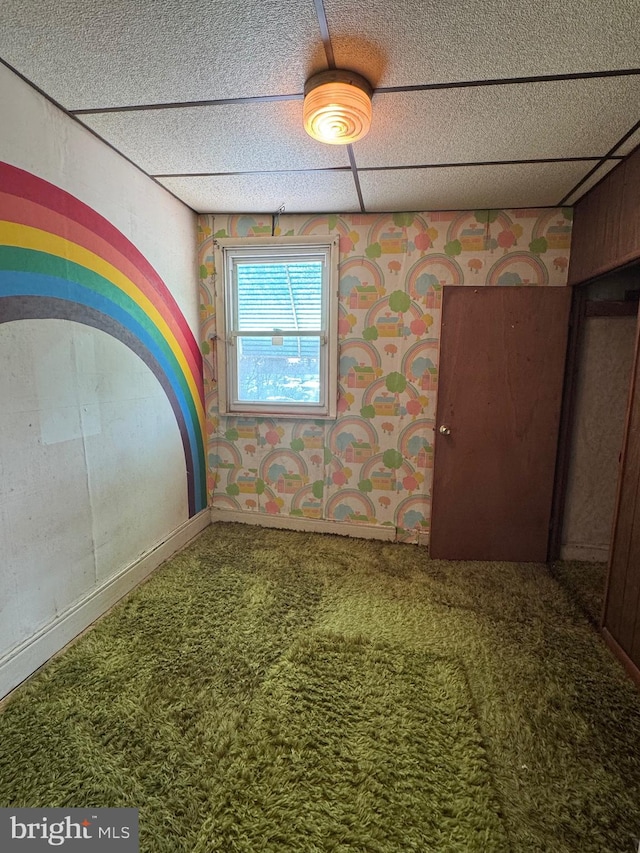 interior space with carpet, a paneled ceiling, and wallpapered walls