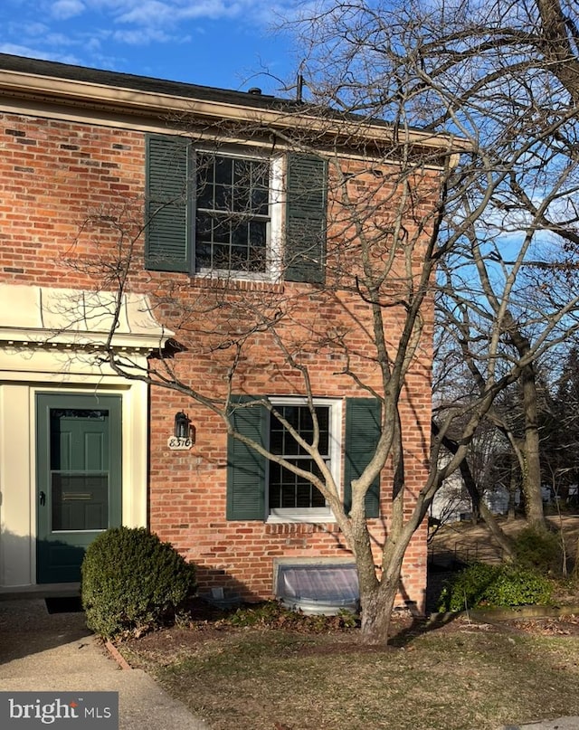 view of side of property with brick siding