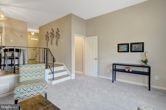 sitting room with stairway, carpet, visible vents, and baseboards