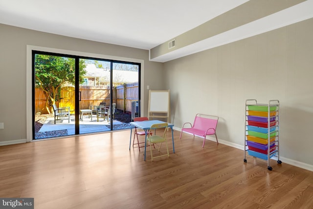 playroom featuring baseboards, visible vents, and wood finished floors