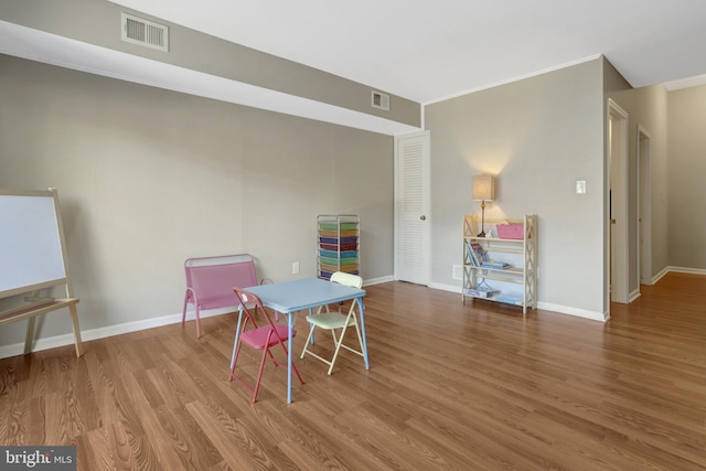 interior space featuring wood finished floors, visible vents, and baseboards