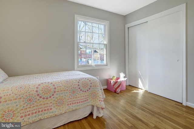 bedroom with light wood-style flooring and baseboards