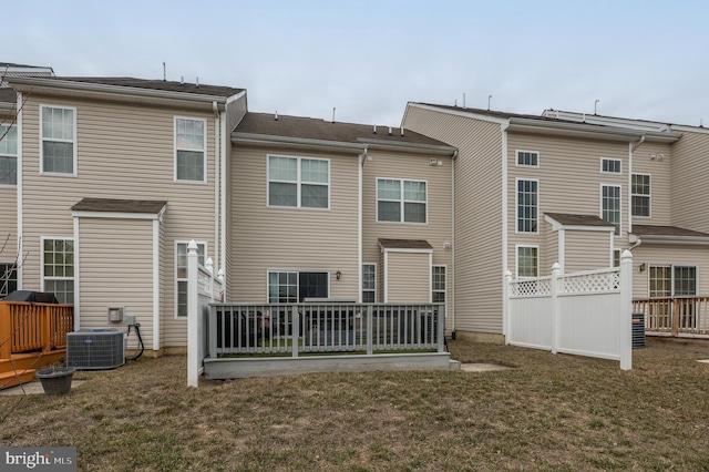 back of house with a yard, cooling unit, and fence