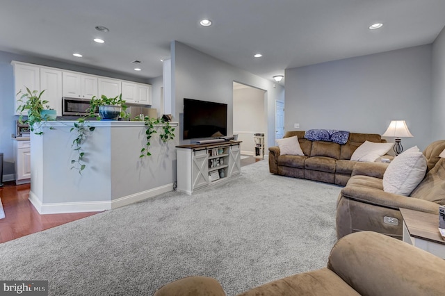 living area with recessed lighting, baseboards, and carpet