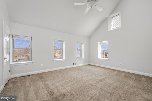 carpeted empty room featuring a ceiling fan, visible vents, a healthy amount of sunlight, and baseboards