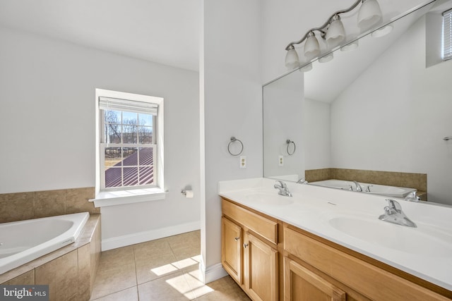 bathroom with tile patterned flooring, double vanity, a garden tub, and a sink