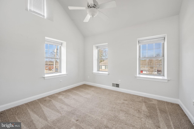 carpeted empty room featuring visible vents, baseboards, lofted ceiling, and ceiling fan