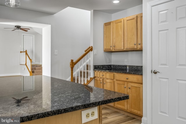 kitchen featuring dark stone counters, recessed lighting, light wood-style floors, and ceiling fan