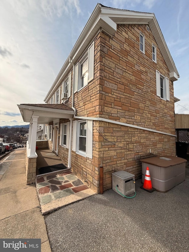 view of property exterior with stone siding