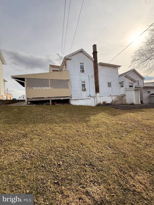 back of property featuring a lawn