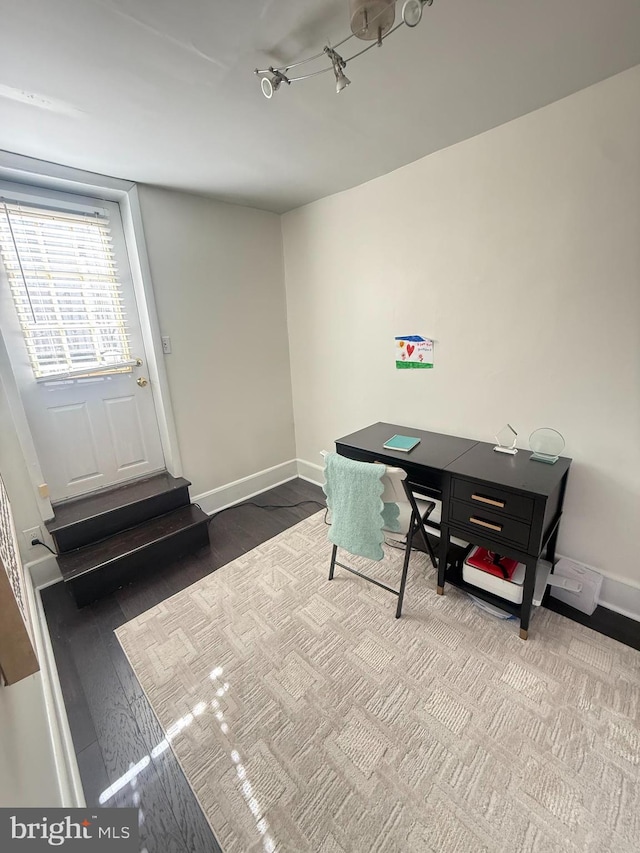 home office with baseboards and wood finished floors