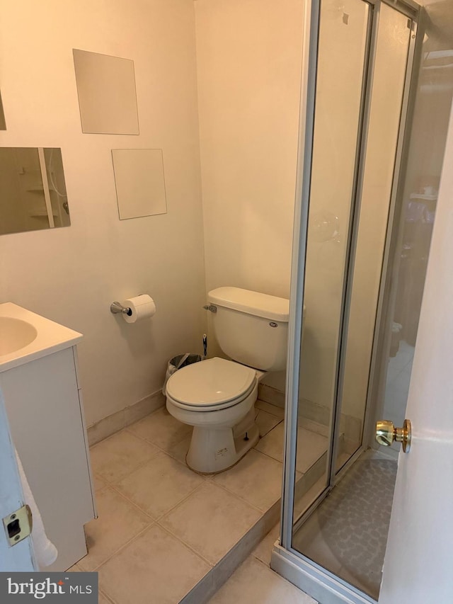 full bathroom with a stall shower, tile patterned flooring, vanity, and toilet