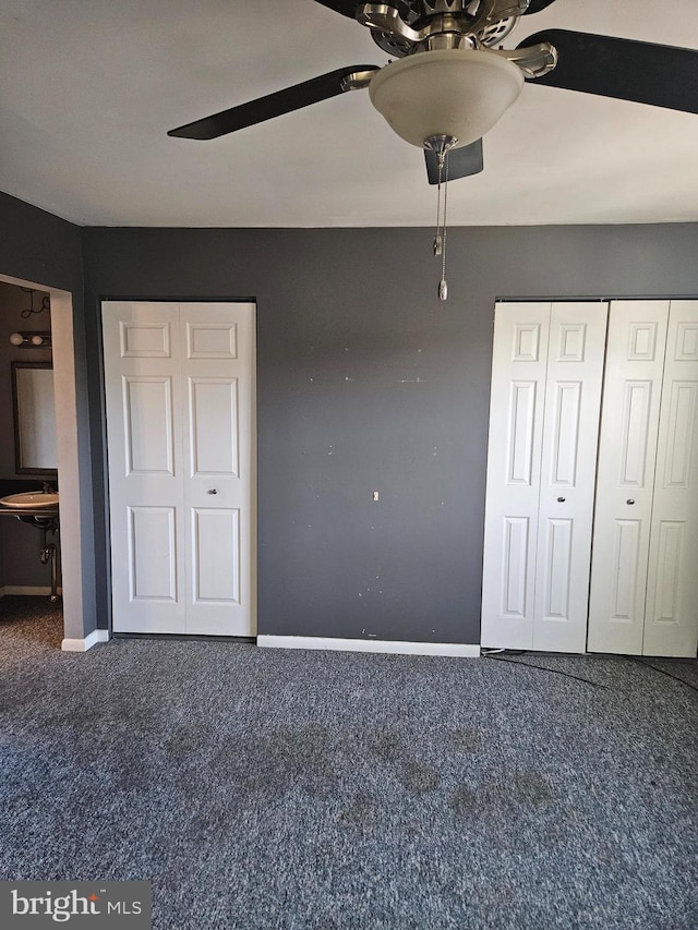 unfurnished bedroom featuring carpet floors, baseboards, and a ceiling fan