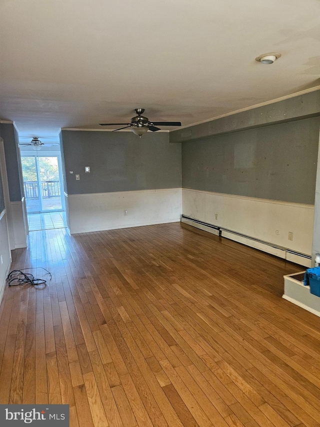 unfurnished living room with a baseboard heating unit, hardwood / wood-style flooring, and a ceiling fan