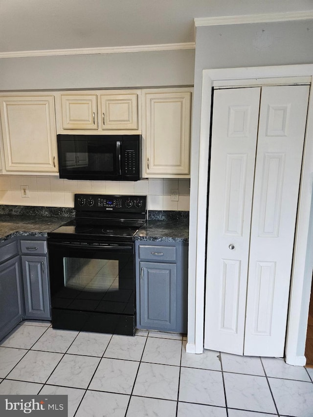 kitchen featuring marble finish floor, ornamental molding, cream cabinetry, black appliances, and dark countertops