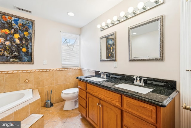 bathroom featuring toilet, tile patterned flooring, a sink, and visible vents