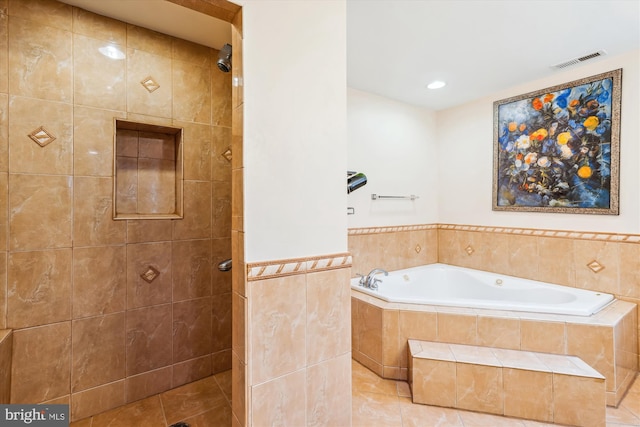 full bathroom featuring a garden tub, tile walls, visible vents, tiled shower, and tile patterned floors