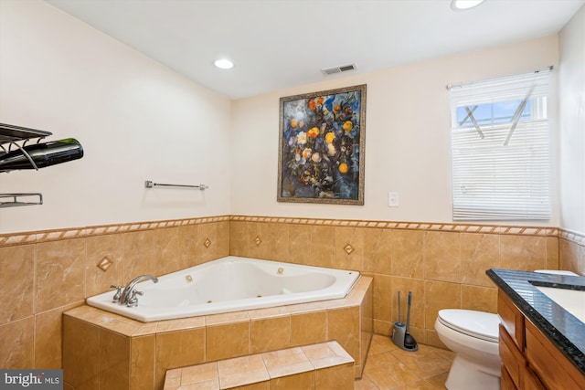 full bathroom featuring visible vents, toilet, tile patterned floors, a whirlpool tub, and vanity