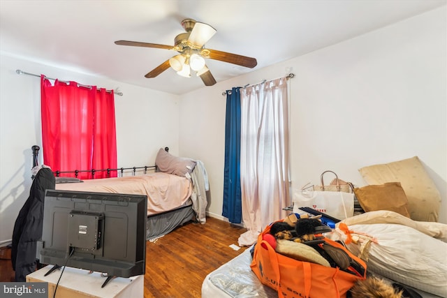 bedroom with a ceiling fan and wood finished floors