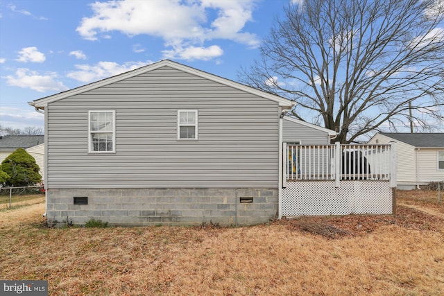 view of side of property featuring crawl space and fence