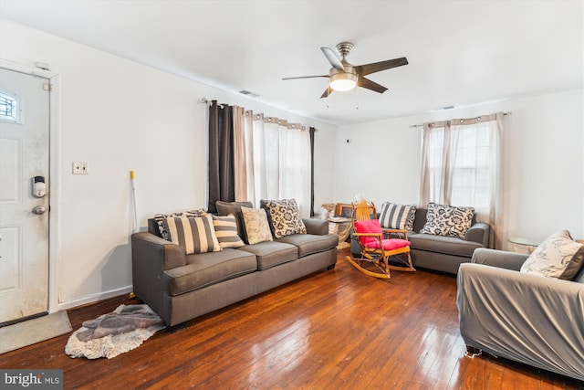 living area featuring a ceiling fan, a healthy amount of sunlight, visible vents, and hardwood / wood-style floors