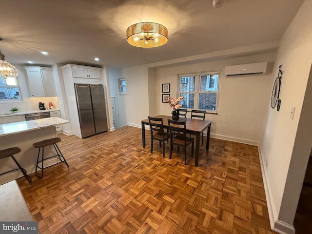 dining area with a wall unit AC, an inviting chandelier, baseboards, and recessed lighting