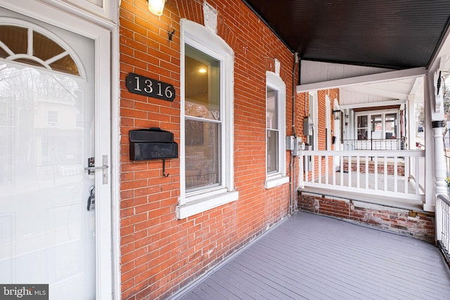 wooden terrace featuring covered porch