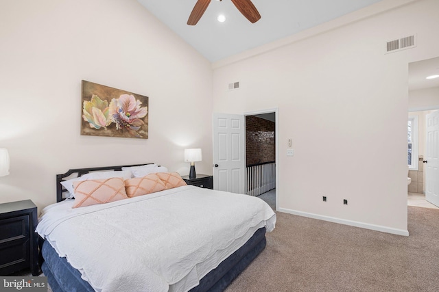 carpeted bedroom featuring high vaulted ceiling, baseboards, visible vents, and connected bathroom