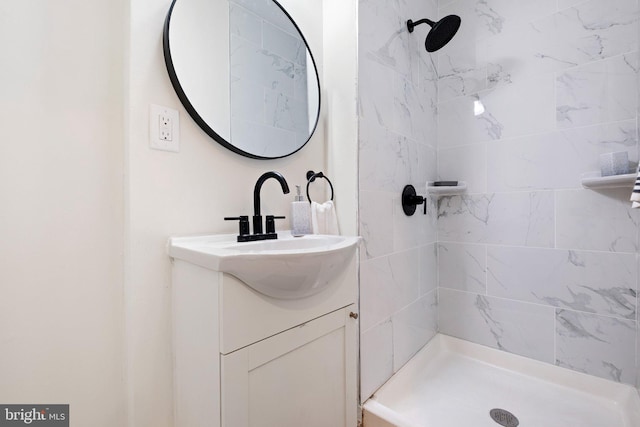 full bathroom with a shower stall and vanity