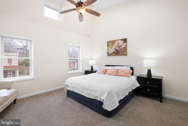 carpeted bedroom with a ceiling fan, multiple windows, high vaulted ceiling, and baseboards