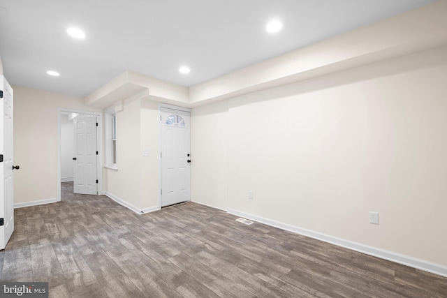 finished below grade area with recessed lighting, visible vents, baseboards, and wood finished floors