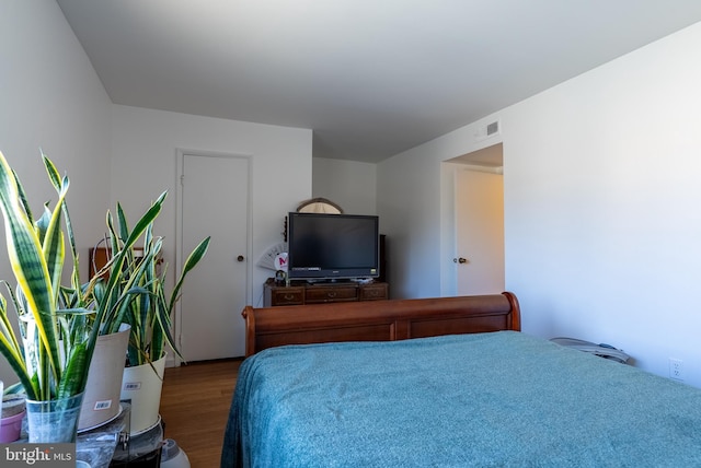 bedroom with wood finished floors and visible vents