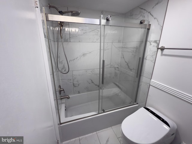 full bathroom featuring toilet, marble finish floor, and combined bath / shower with glass door