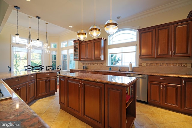 kitchen with ornamental molding, stainless steel dishwasher, a sink, and tasteful backsplash