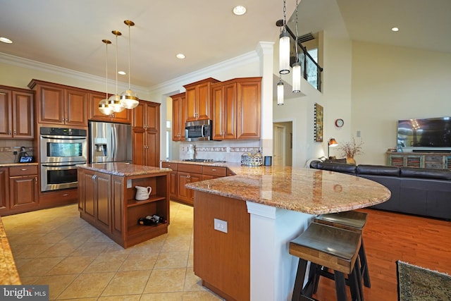 kitchen featuring appliances with stainless steel finishes, brown cabinets, ornamental molding, light stone countertops, and open shelves