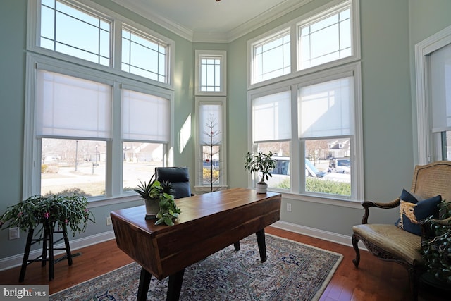 home office featuring baseboards, ornamental molding, a wealth of natural light, and wood finished floors