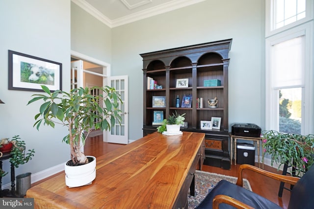 office area with crown molding, baseboards, and wood finished floors