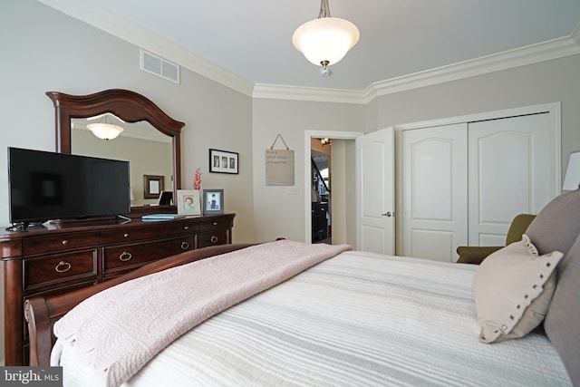 bedroom featuring visible vents, a closet, and ornamental molding