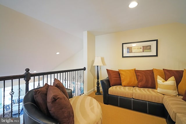 living area with lofted ceiling, baseboards, and recessed lighting