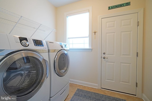 laundry room with laundry area, baseboards, washing machine and clothes dryer, and light tile patterned floors