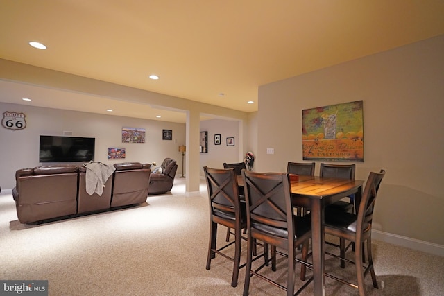 dining area with light carpet, baseboards, and recessed lighting