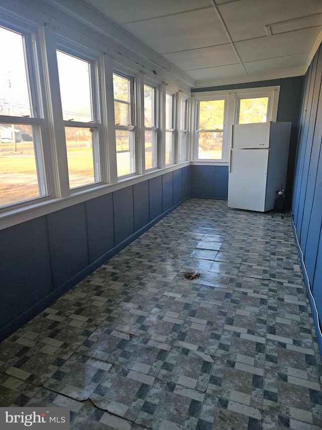 unfurnished sunroom featuring a paneled ceiling