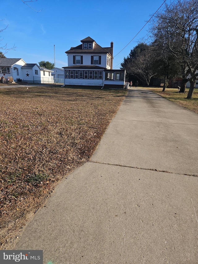 view of front of home featuring a sunroom