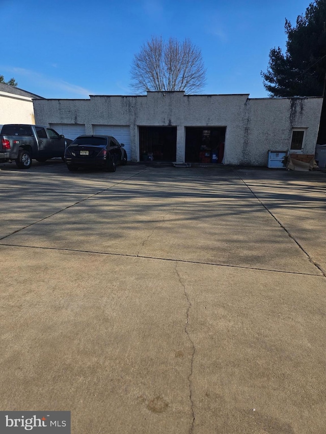 view of property featuring concrete driveway