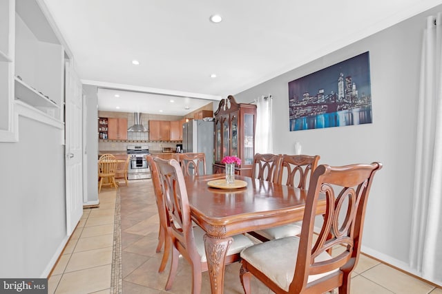 dining space featuring baseboards, light tile patterned flooring, and recessed lighting