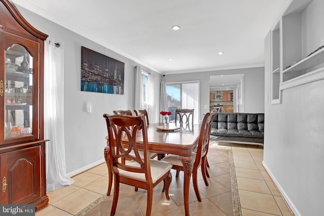 dining room featuring crown molding, light tile patterned floors, recessed lighting, and baseboards