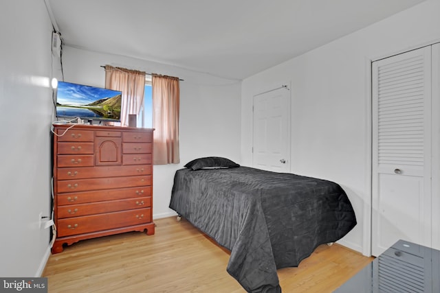 bedroom featuring baseboards and wood finished floors