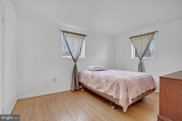 bedroom featuring wood finished floors and baseboards