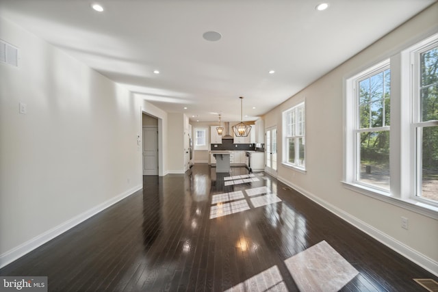 interior space featuring dark wood-style floors, recessed lighting, visible vents, and baseboards