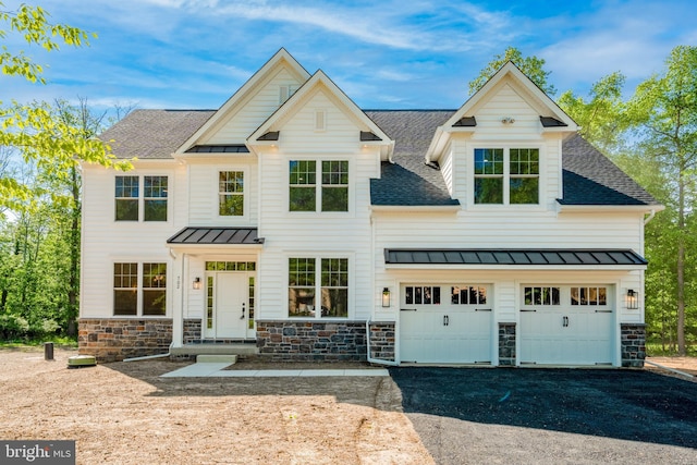 view of front facade with stone siding, a standing seam roof, roof with shingles, and driveway